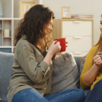 videoblocks-two-women-sitting-on-the-sofa-sipping-a-tea-and-talking-friendly-in-the-cozy-home-atmosphere-indoors_s57dhad1fg_thumbnail-full01
